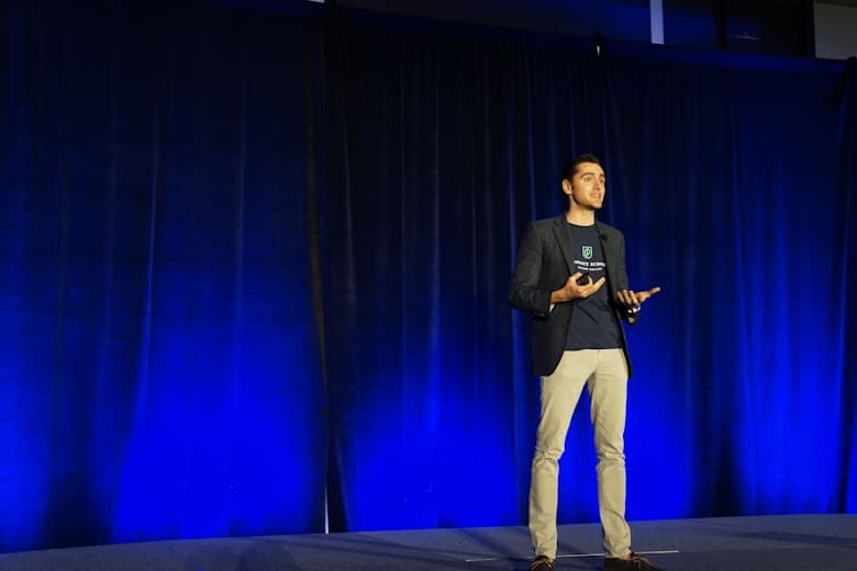 Speaker presenting on a conference stage