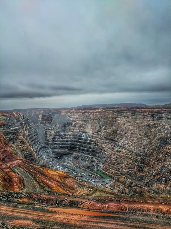Aerial view of an open-pit mine under overcast skies